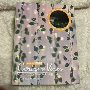 Curtain vines, consistent of cascading, vine, strands in string lights.